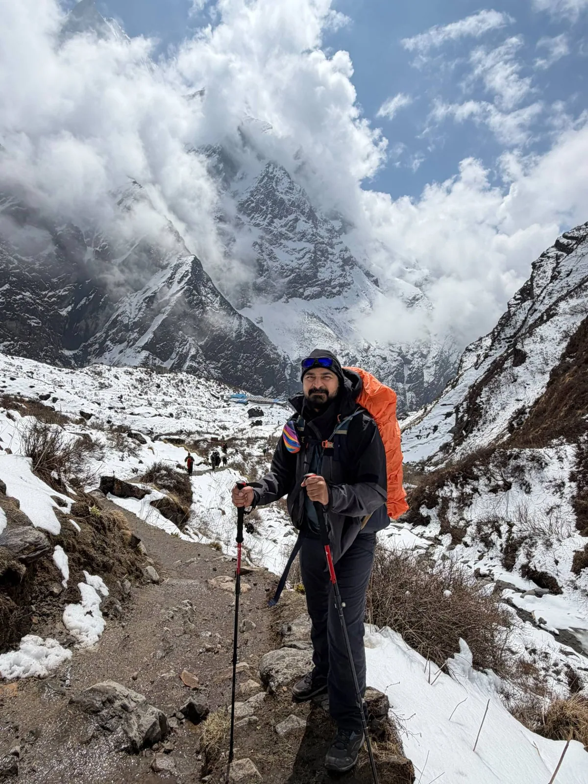 On the trail between the two base camps, with Machhapuchhre in the clouds behind